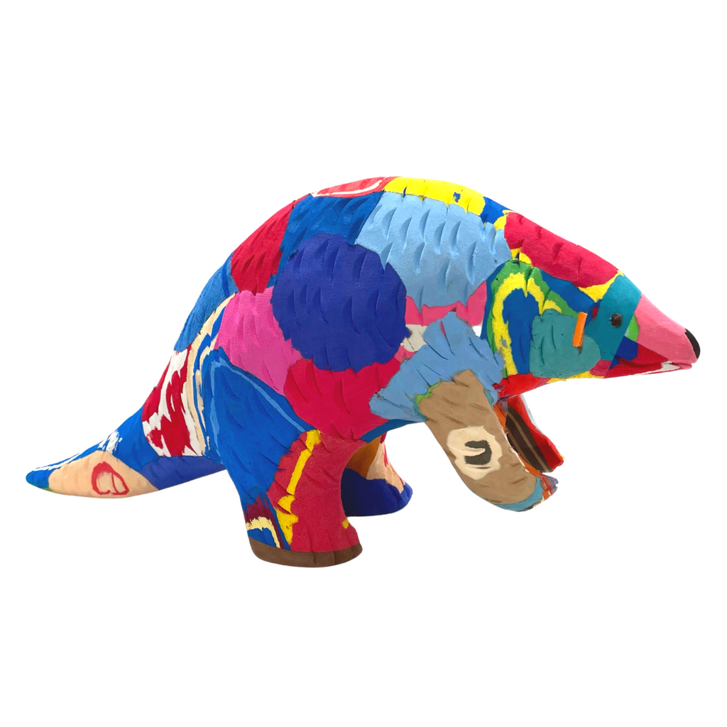 Hand-carved multicolored pangolin sculpture made of upcycled flip flops by Ocean Sole.