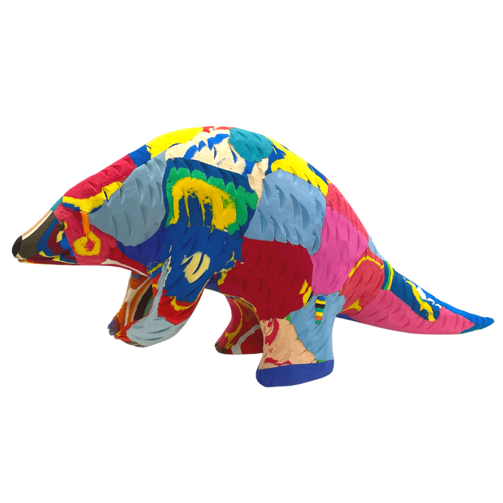 Hand-carved multicolored pangolin sculpture made of upcycled flip flops by Ocean Sole.