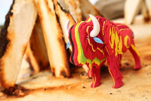 Hand-carved multicolored bison sculpture made of upcycled flip flops by Ocean Sole.