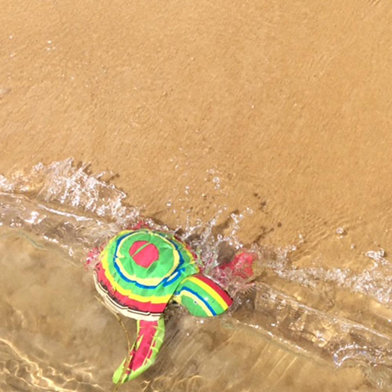 Hand-carved multicolored turtle sculpture made of upcycled flip flops by Ocean Sole.