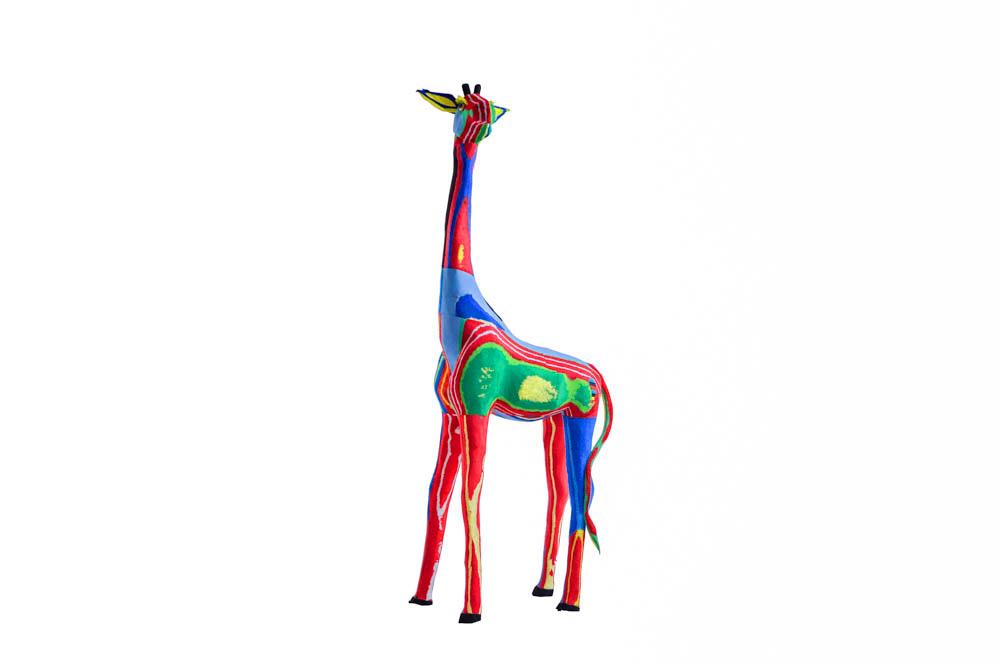 Hand-carved multicolored giraffe sculpture made of upcycled flip flops by Ocean Sole.