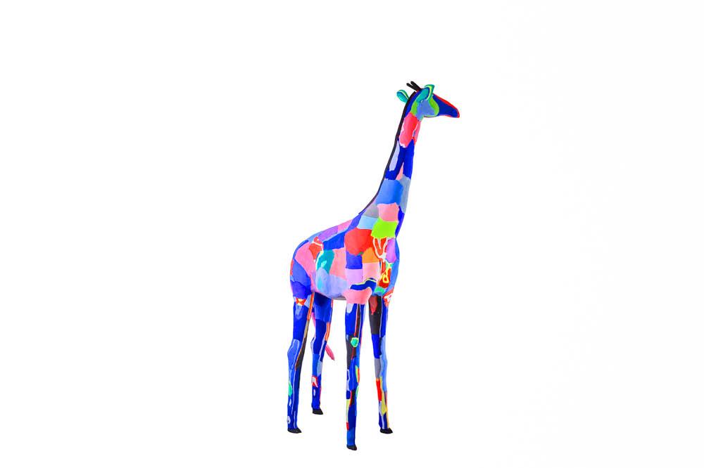 Hand-carved multicolored giraffe sculpture made of upcycled flip flops by Ocean Sole.