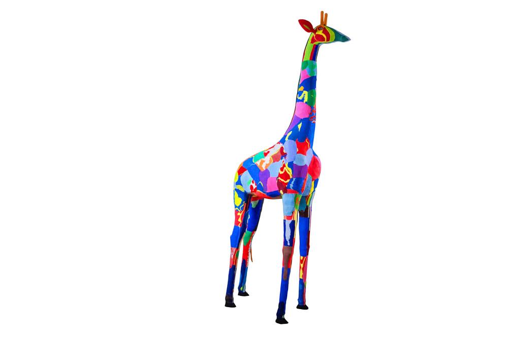 Hand-carved multicolored giraffe sculpture made of upcycled flip flops by Ocean Sole.