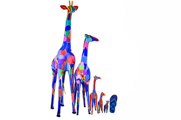 Five hand-carved multicolored giraffe sculptures made of upcycled flip flops by Ocean Sole lined up in size comparison to a flip flop.
