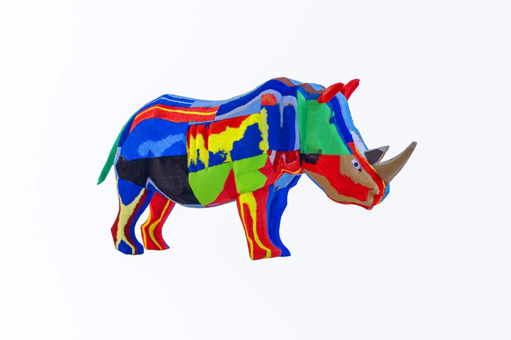 Hand-carved multicolored rhino sculpture made of upcycled flip flops by Ocean Sole.