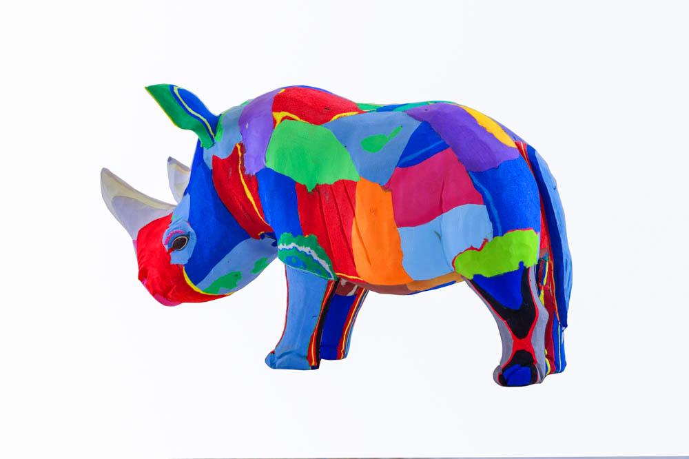 Hand-carved multicolored rhino sculpture made of upcycled flip flops by Ocean Sole.