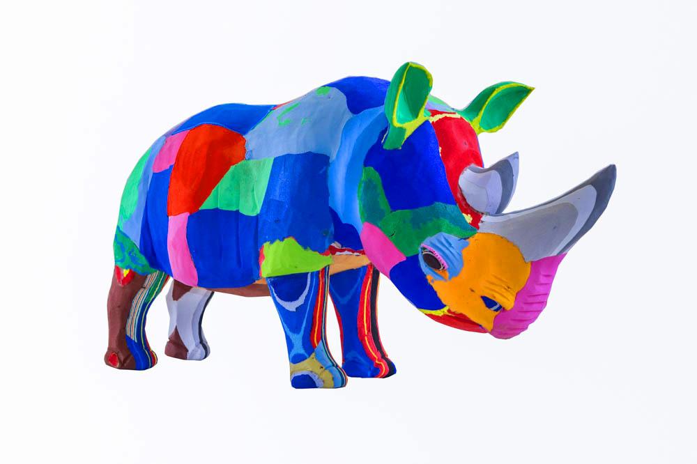 Hand-carved multicolored rhino sculpture made of upcycled flip flops by Ocean Sole.