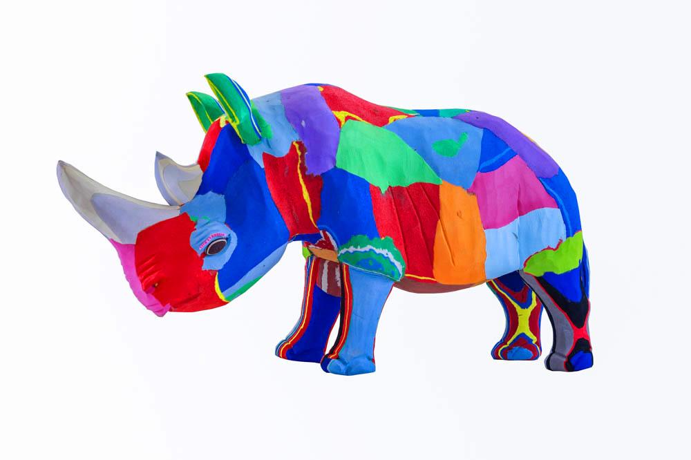 Hand-carved multicolored rhino sculpture made of upcycled flip flops by Ocean Sole.