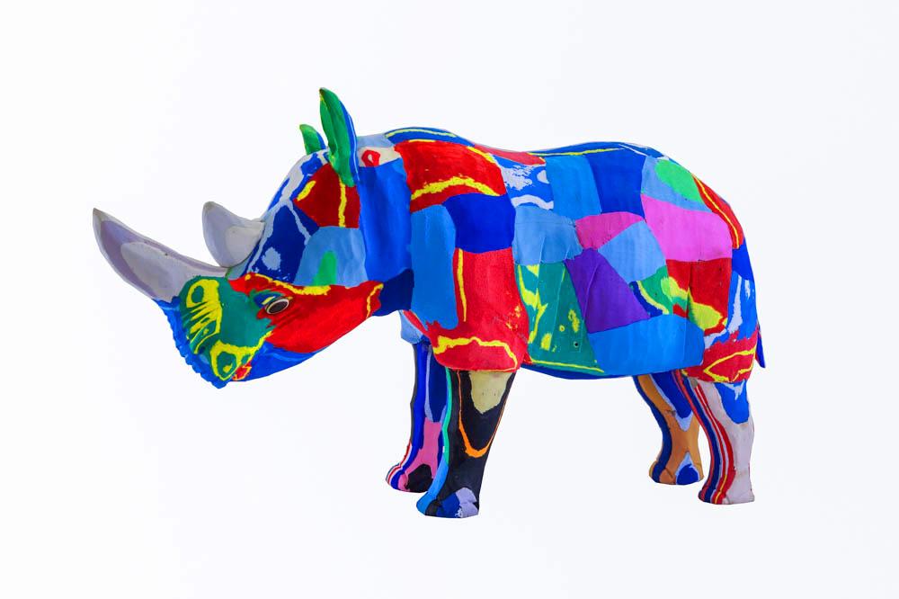 Hand-carved multicolored rhino sculpture made of upcycled flip flops by Ocean Sole.