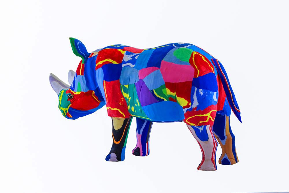 Hand-carved multicolored rhino sculpture made of upcycled flip flops by Ocean Sole.