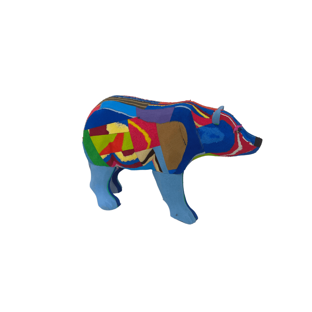 Hand-carved multicolored polar bear sculpture made of upcycled flip flops by Ocean Sole.