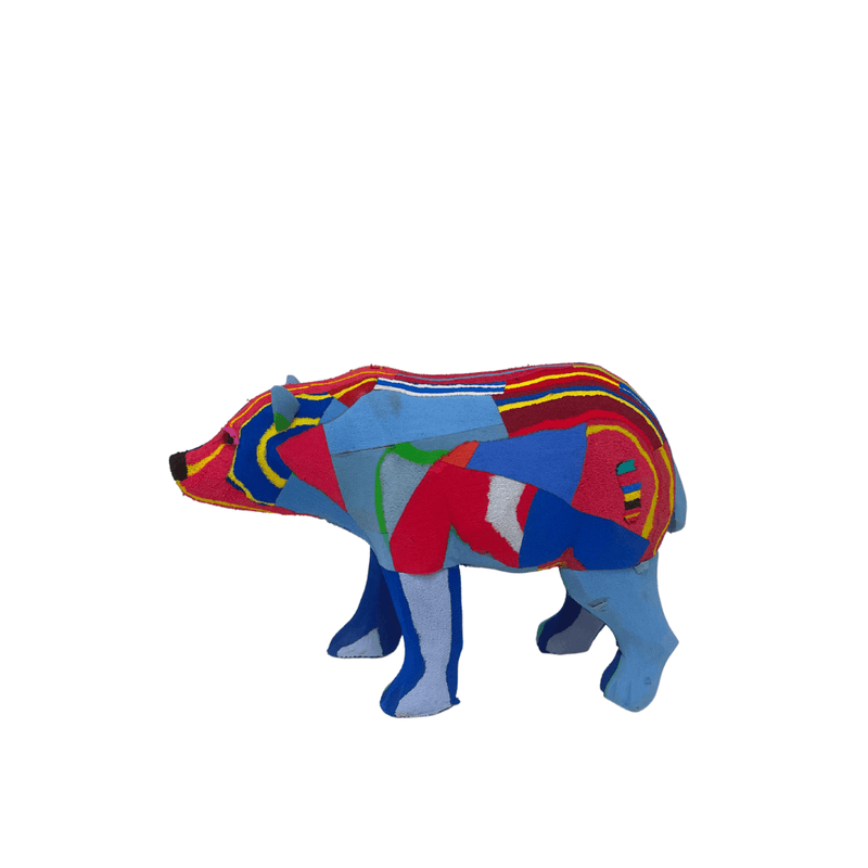 Hand-carved multicolored polar bear sculpture made of upcycled flip flops by Ocean Sole.