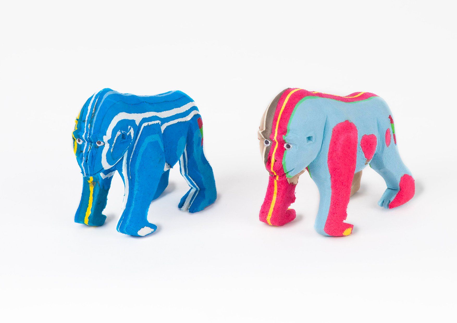Two hand-carved multicolored standing gorilla sculpture made of upcycled flip flops by Ocean Sole.