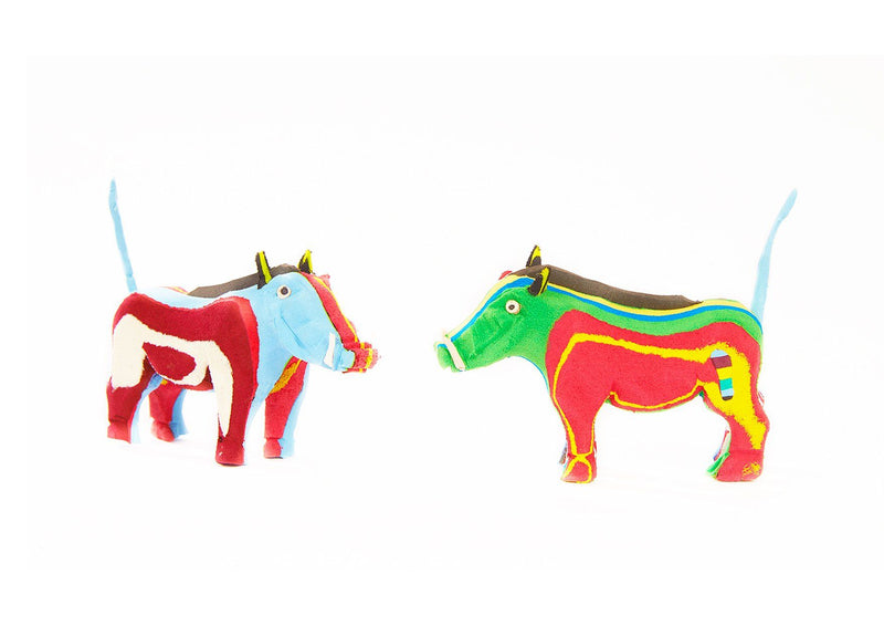 Two hand-carved multicolored warthog sculptures made of upcycled flip flops by Ocean Sole.