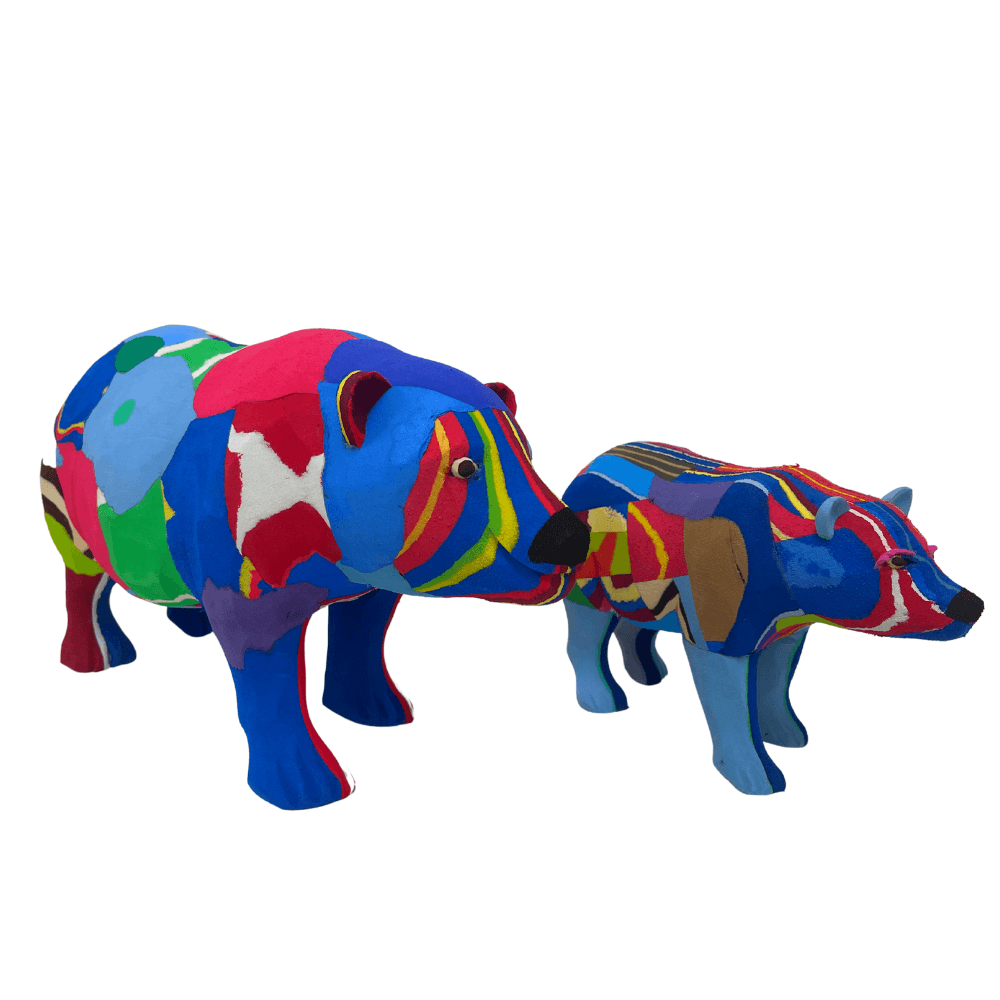 Two hand-carved multicolored polar bear sculpture made of upcycled flip flops by Ocean Sole.