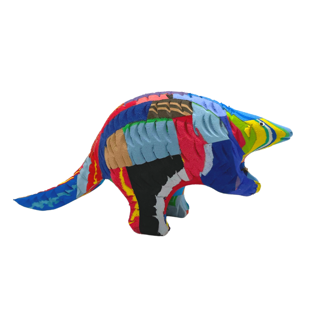 Hand-carved multicolored pangolin sculpture made of upcycled flip flops by Ocean Sole.