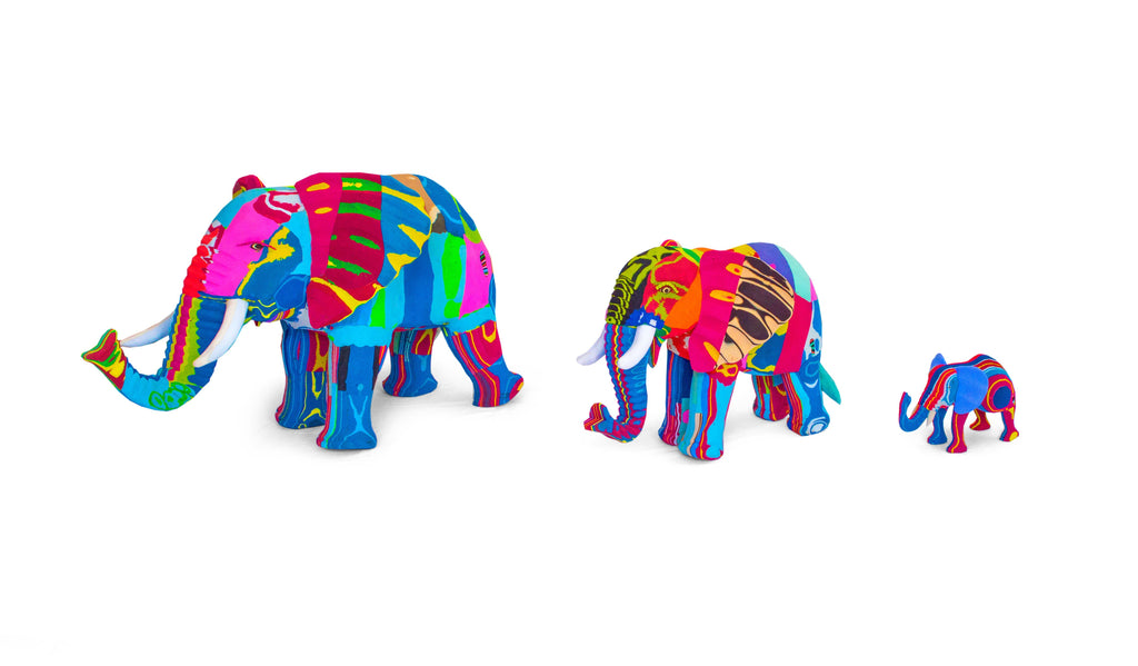 Three hand-carved multicolored elephant sculptures made of upcycled flip flops by Ocean Sole lined up in size comparison.