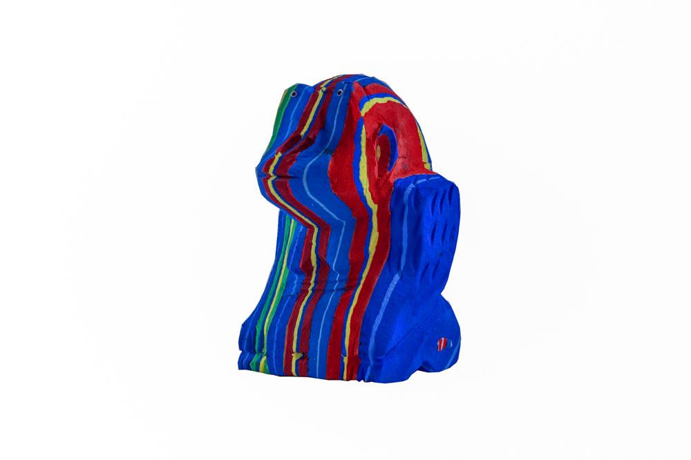 Hand-carved multicolored sitting gorilla sculpture made of upcycled flip flops by Ocean Sole.