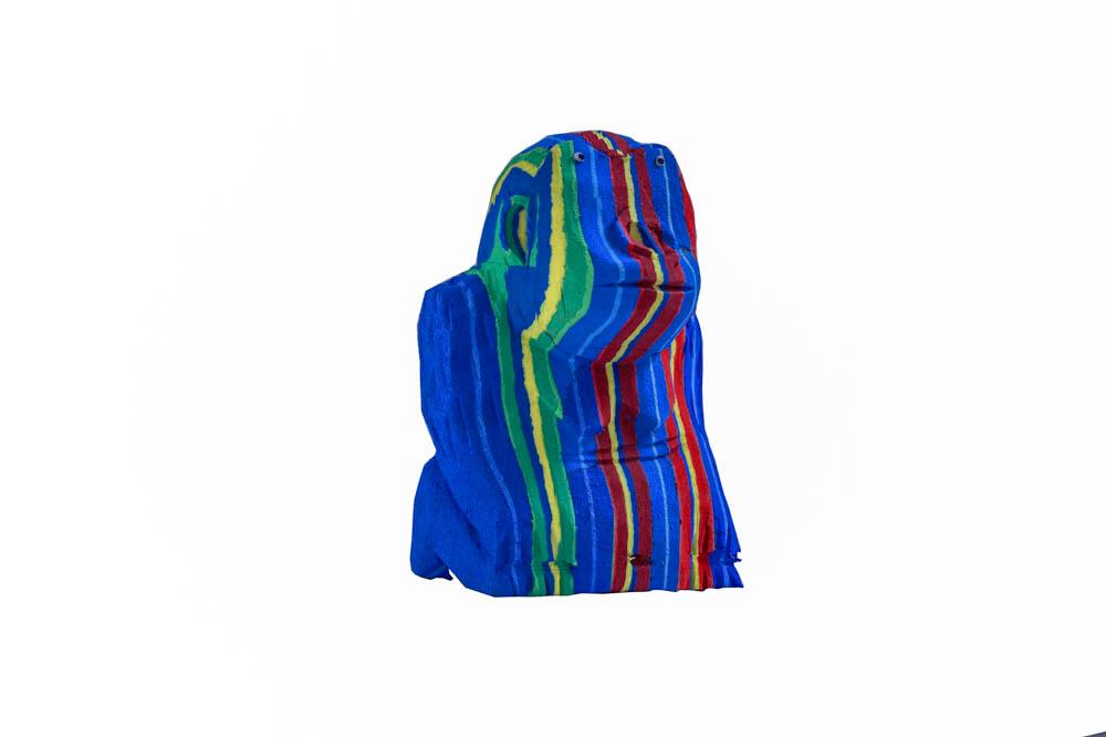 Hand-carved multicolored sitting gorilla sculpture made of upcycled flip flops by Ocean Sole.