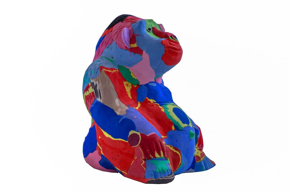 Hand-carved multicolored sitting gorilla sculpture made of upcycled flip flops by Ocean Sole.