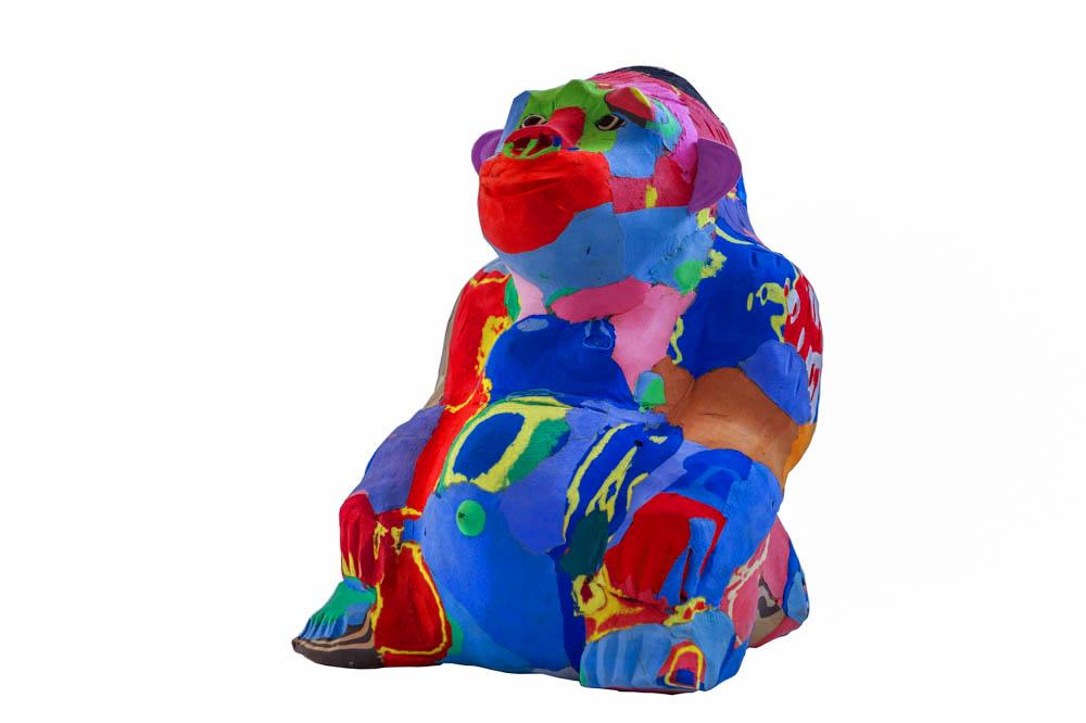 Hand-carved multicolored sitting gorilla sculpture made of upcycled flip flops by Ocean Sole.