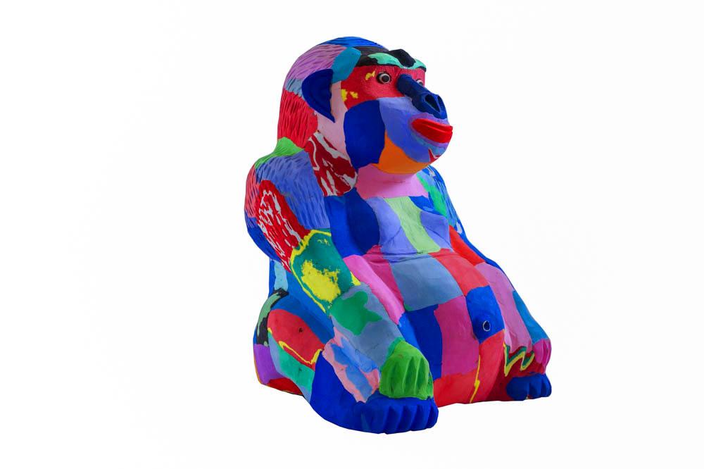 Hand-carved multicolored sitting gorilla sculpture made of upcycled flip flops by Ocean Sole.