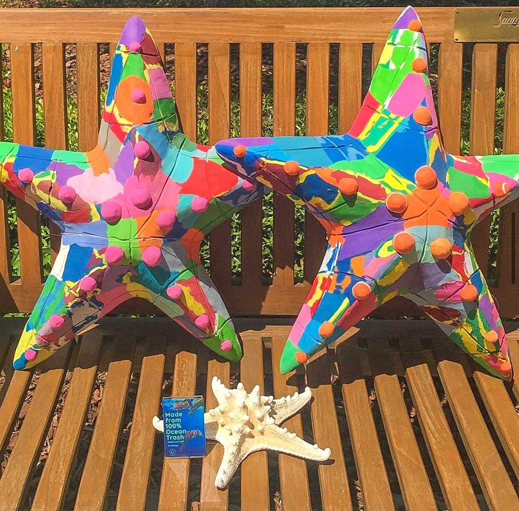 Two hand-carved multicolored starfish sculpture made of upcycled flip flops by Ocean Sole.