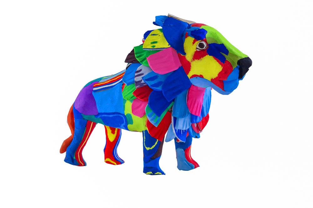 Hand-carved multicolored standing lion sculpture made of upcycled flip flops by Ocean Sole.