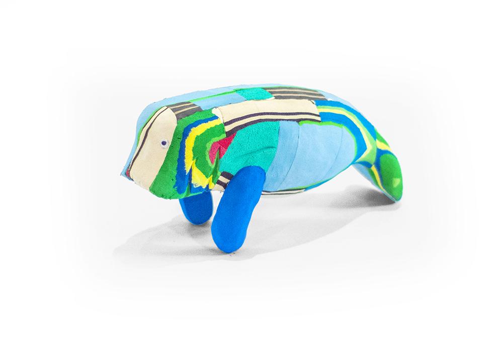 Hand-carved multicolored manatee sculpture made of upcycled flip flops by Ocean Sole.