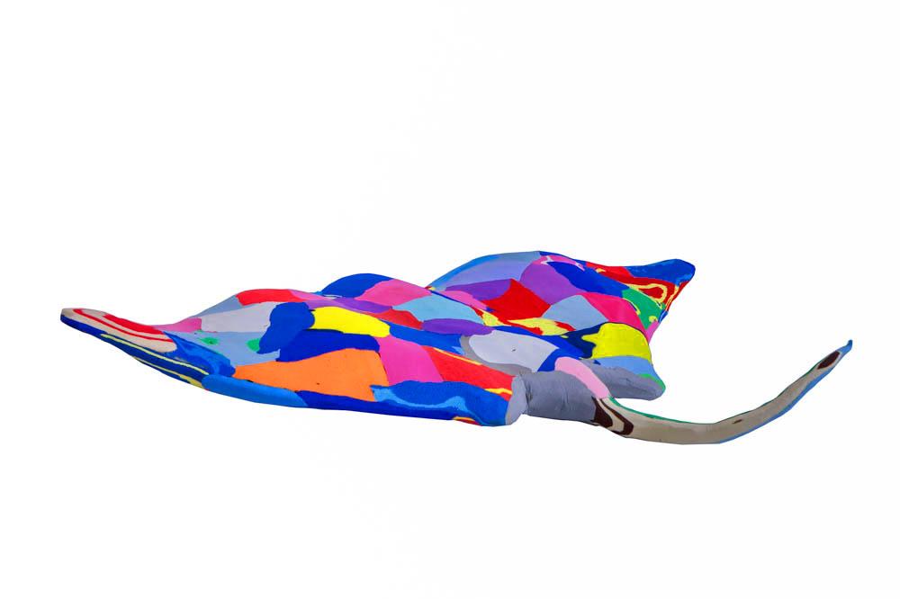 Hand-carved multicolored manta ray sculpture made of upcycled flip flops by Ocean Sole.