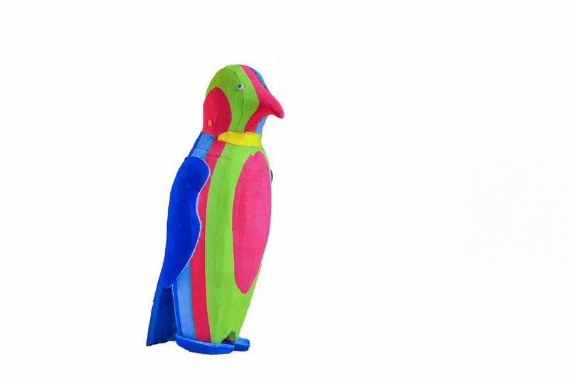 Hand-carved multicolored penguin sculpture made of upcycled flip flops by Ocean Sole.