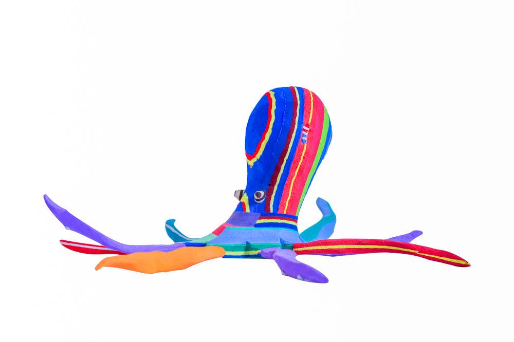 Hand-carved multicolored octopus sculpture made of upcycled flip flops by Ocean Sole.