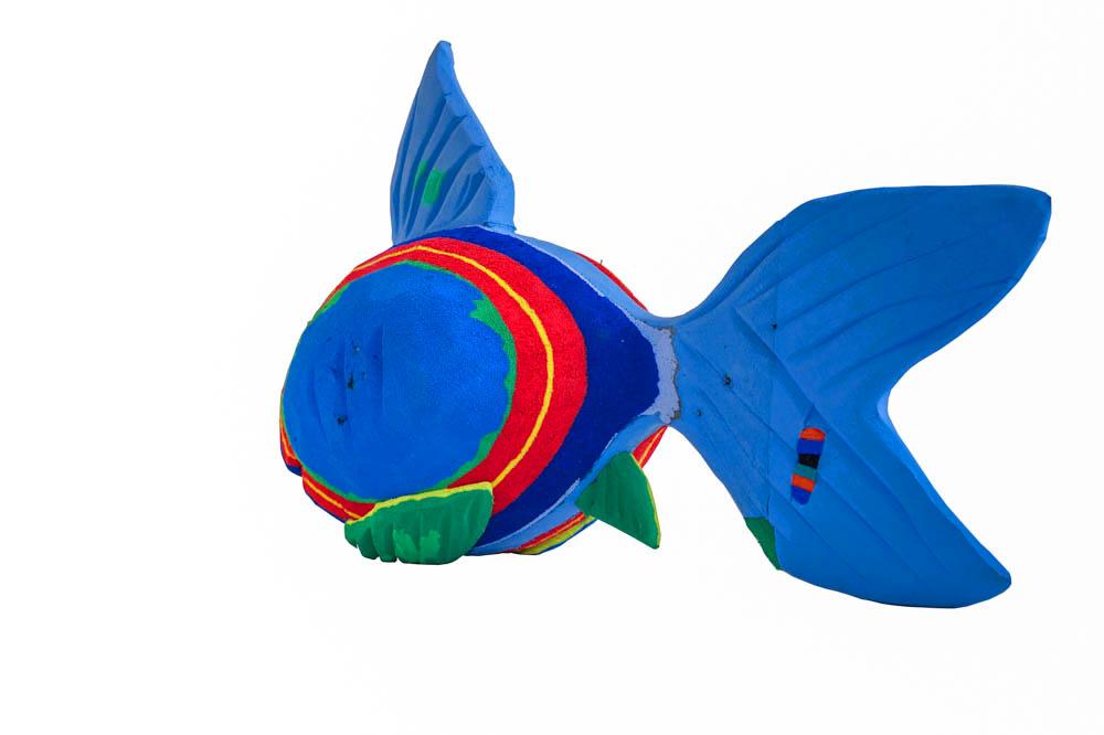 Hand-carved multicolored reef fish sculpture made of upcycled flip flops by Ocean Sole.