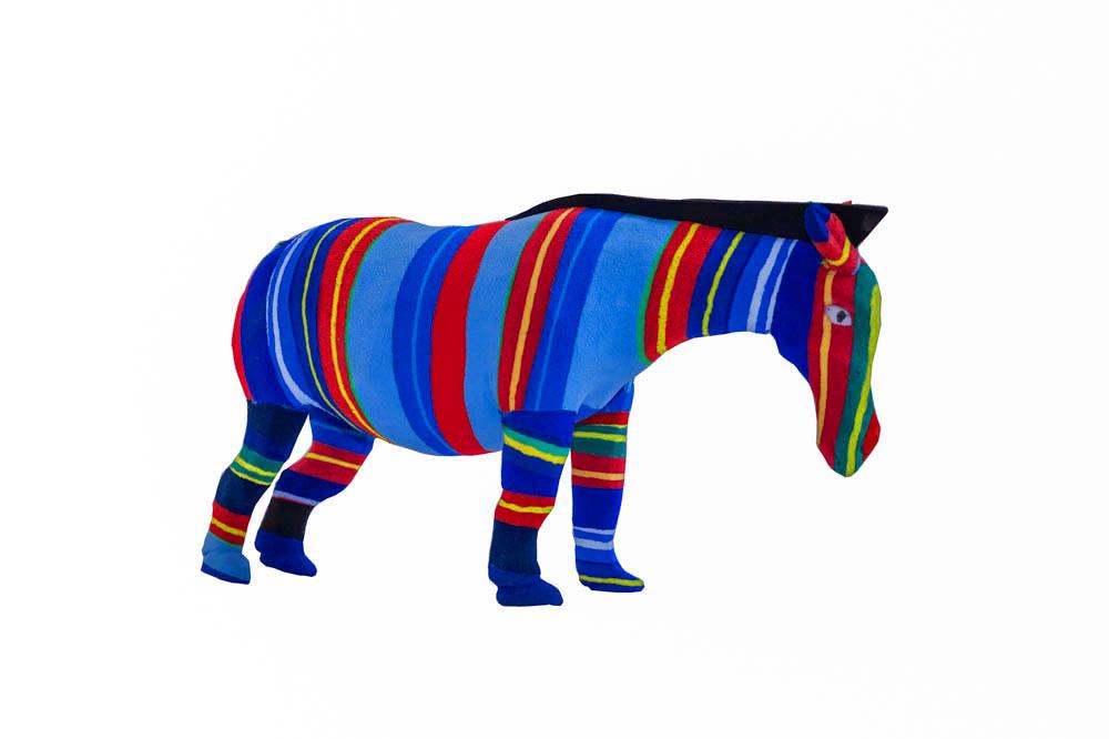Hand-carved multicolored zebra sculpture made of upcycled flip flops by Ocean Sole.