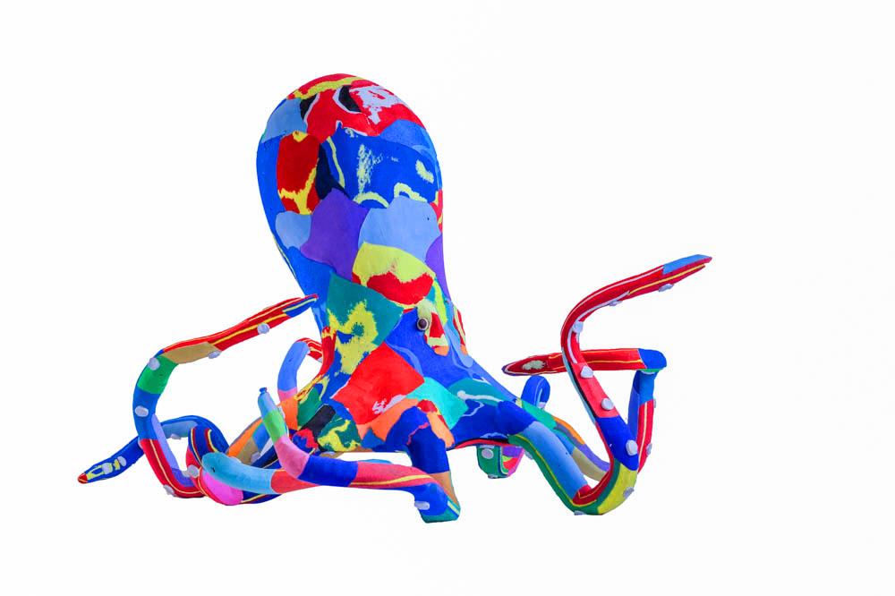 Large hand-carved multicolored octopus sculpture made of upcycled flip flops by Ocean Sole.