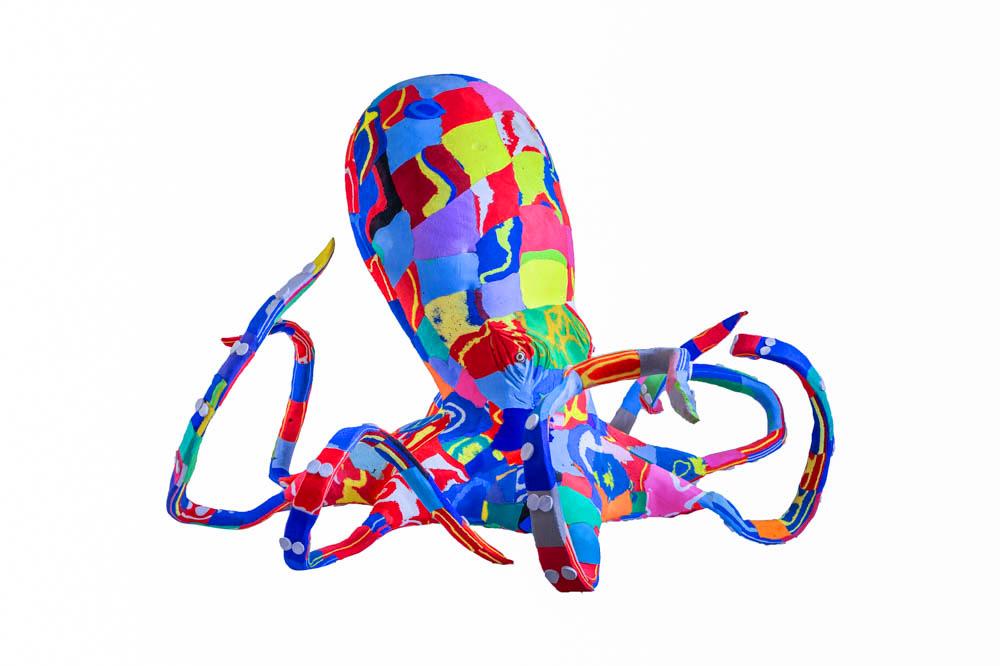 Large hand-carved multicolored octopus sculpture made of upcycled flip flops by Ocean Sole.