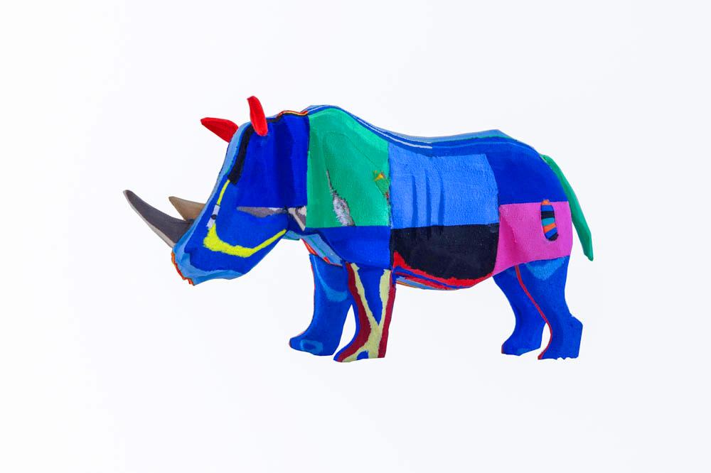 Hand-carved multicolored rhino sculpture made of upcycled flip flops by Ocean Sole.