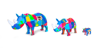 Three hand-carved multicolored rhino sculptures made of upcycled flip flops by Ocean Sole lined up in size comparison.