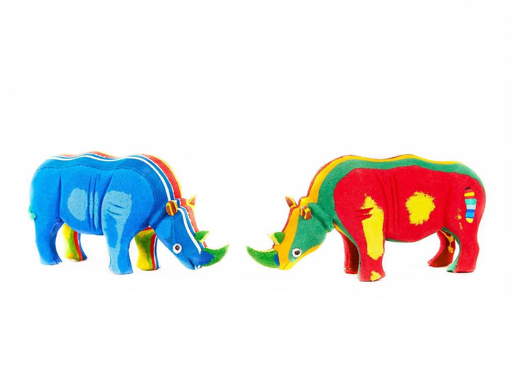 Two hand-carved multicolored rhino sculpture made of upcycled flip flops by Ocean Sole.