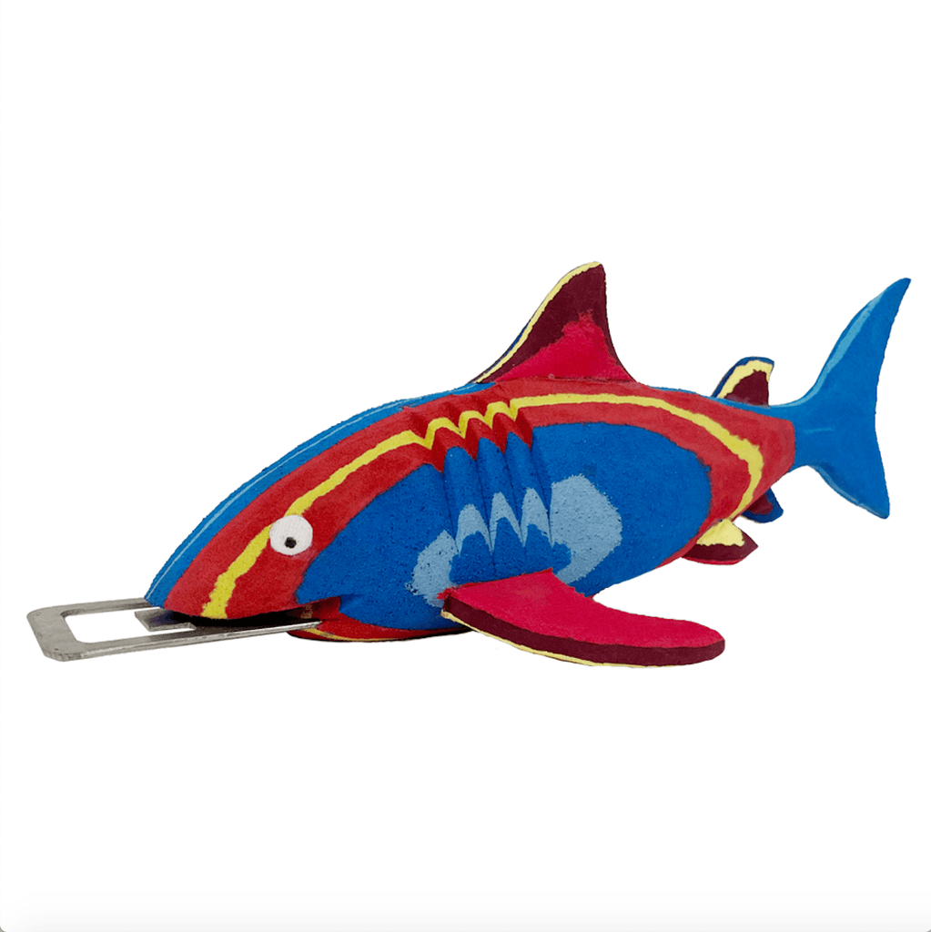 Hand-carved multicolored shark bottle opener made of upcycled flip flops by Ocean Sole.