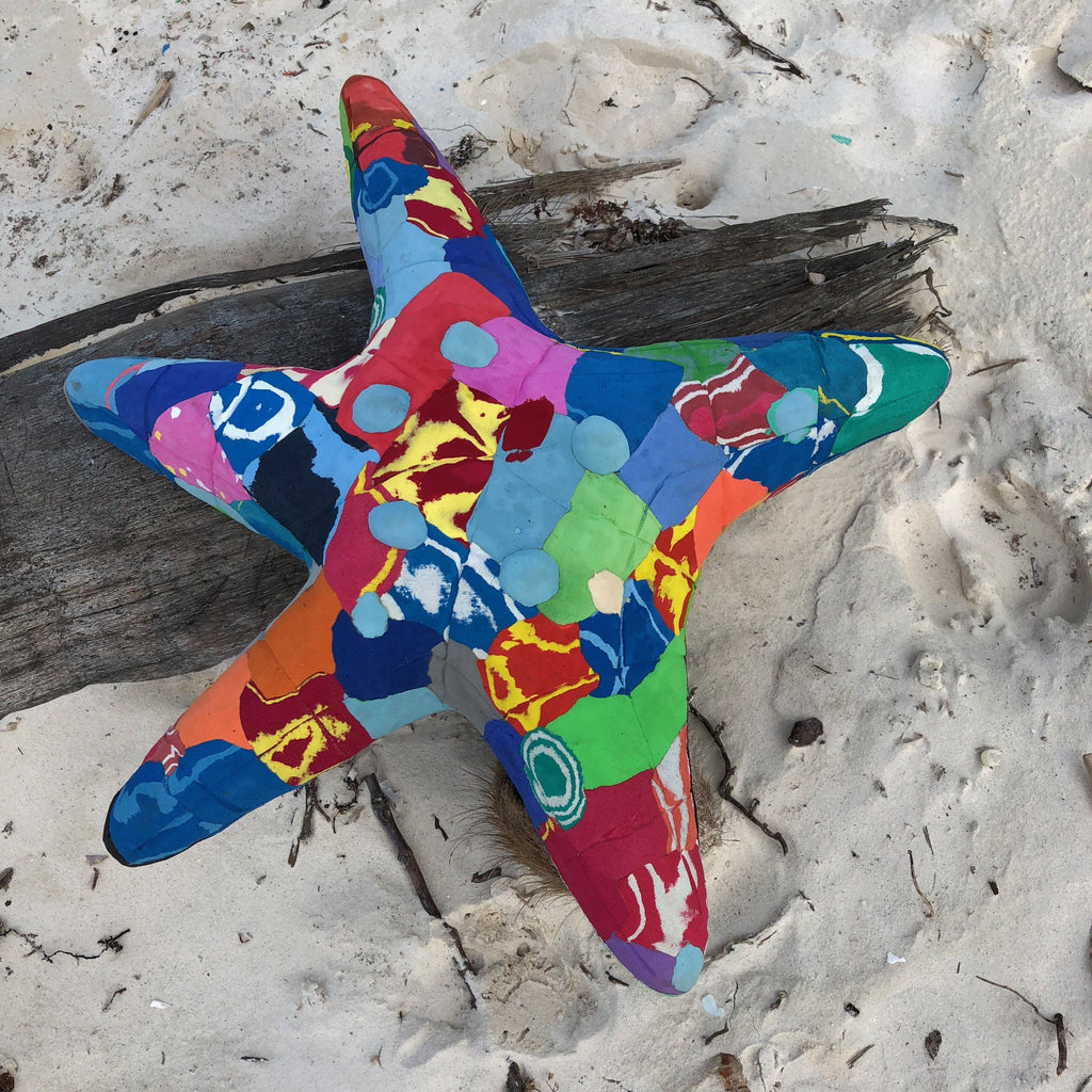 Hand-carved multicolored starfish sculpture made of upcycled flip flops by Ocean Sole.