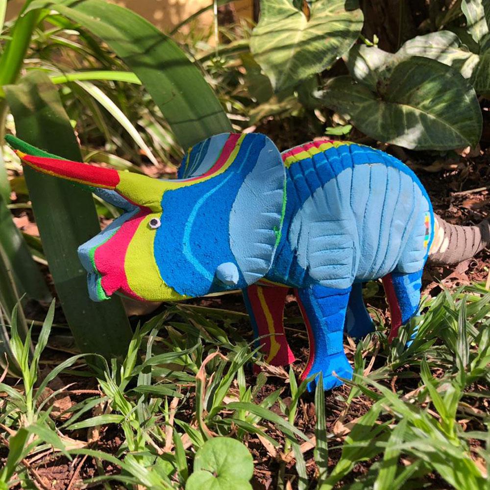 Hand-carved multicolored triceratops sculpture made of upcycled flip flops by Ocean Sole.