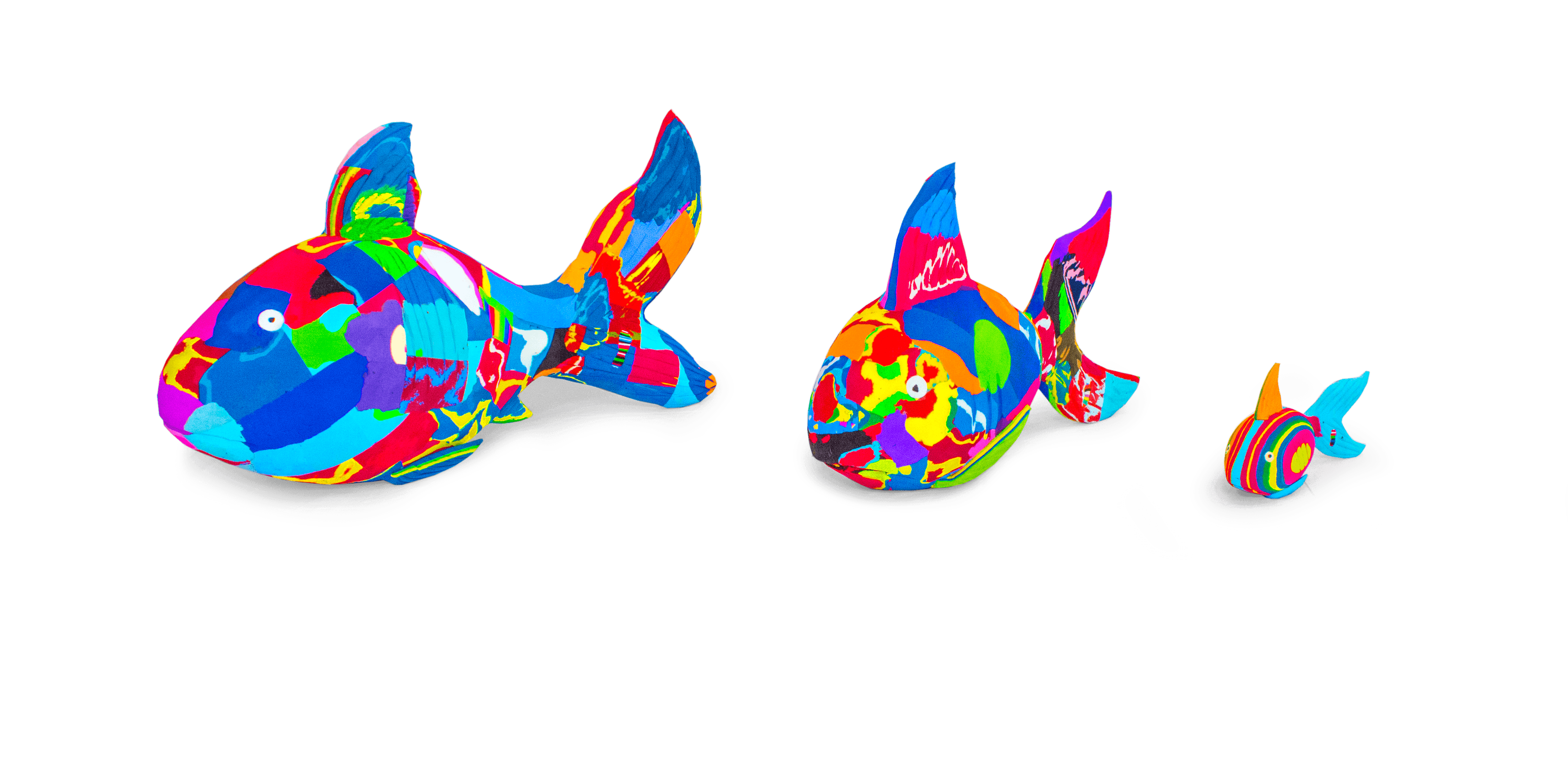 Three hand-carved multicolored reef fish sculptures made of upcycled flip flops by Ocean Sole lined up in size comparison.