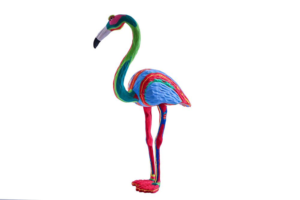 Hand-carved multicolored standing flamingo sculpture made of upcycled flip flops by Ocean Sole.