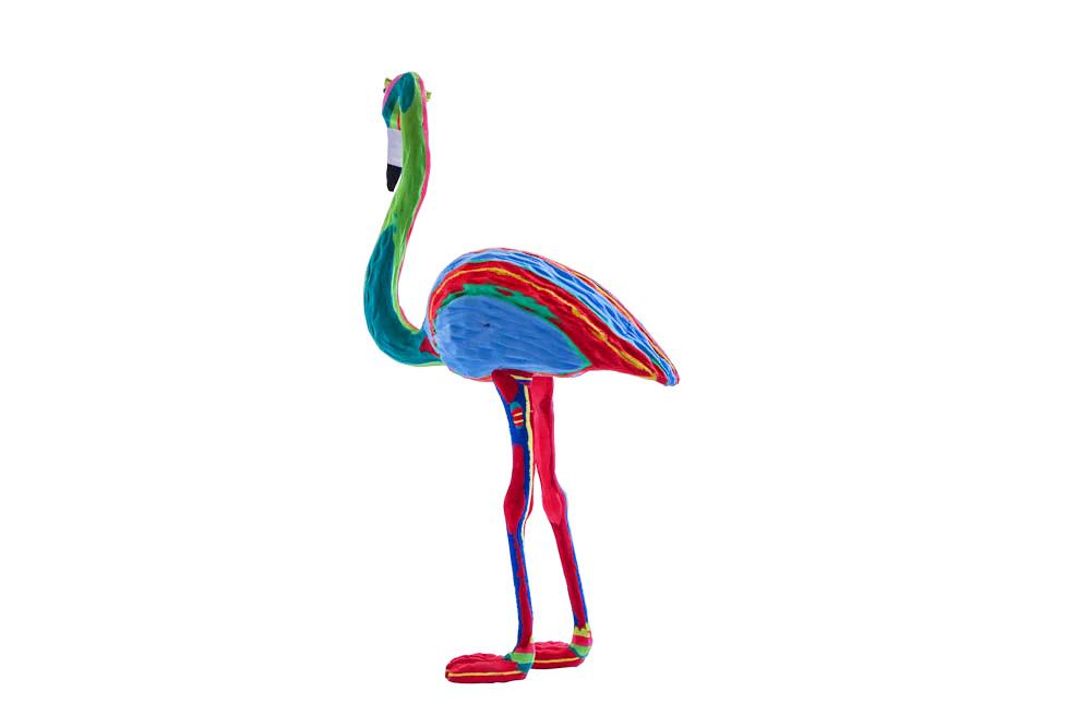 Hand-carved multicolored flamingo sculpture made of upcycled flip flops by Ocean Sole.