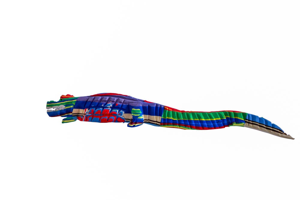 Artisan hand-carved multicolored alligator sculpture made of upcycled flip flops by Ocean Sole.