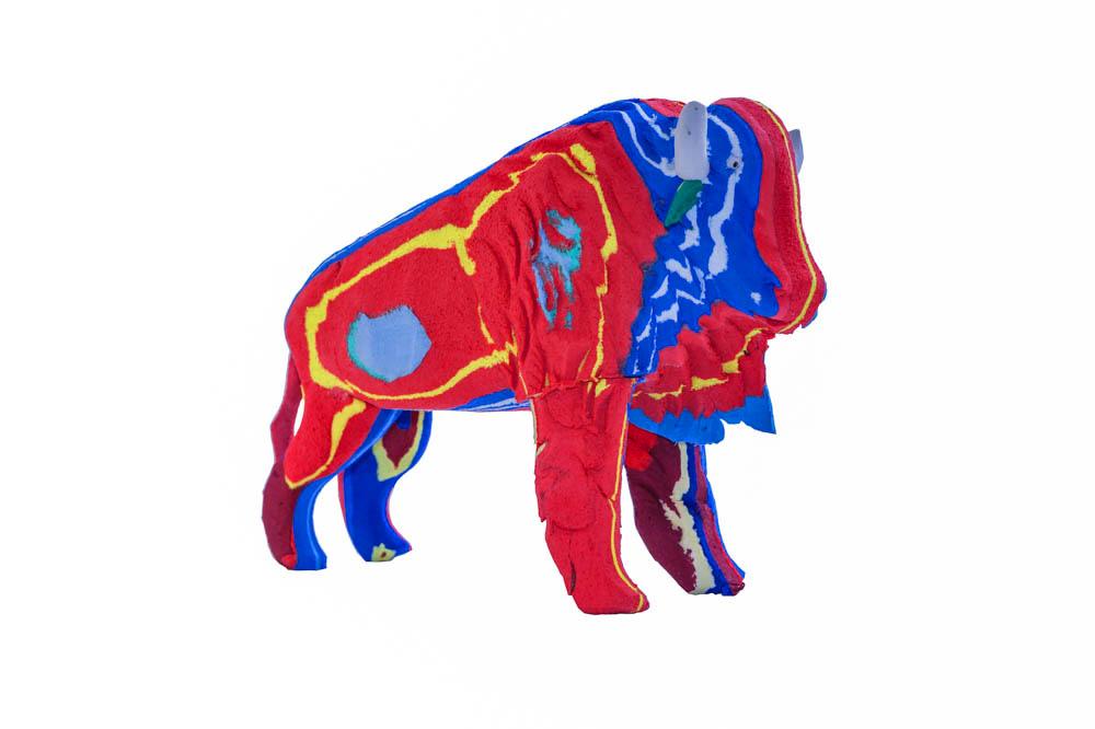 Hand-carved multicolored bison sculpture made of upcycled flip flops by Ocean Sole.