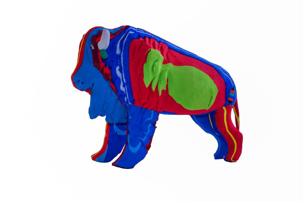 Hand-carved multicolored bison sculpture made of upcycled flip flops by Ocean Sole.