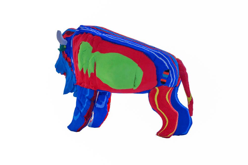 Hand-carved multicolored bison sculpture made of upcycled flip flops by Ocean Sole.