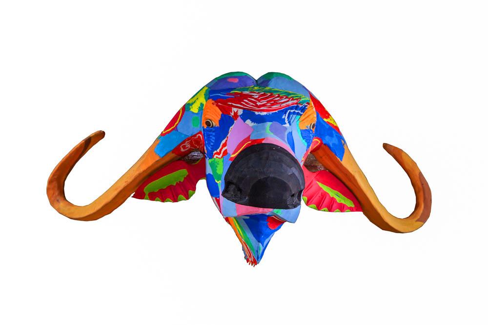 Hand-carved multicolored buffalo wall art sculpture made of upcycled flip flops by Ocean Sole designed to hang on your wall.